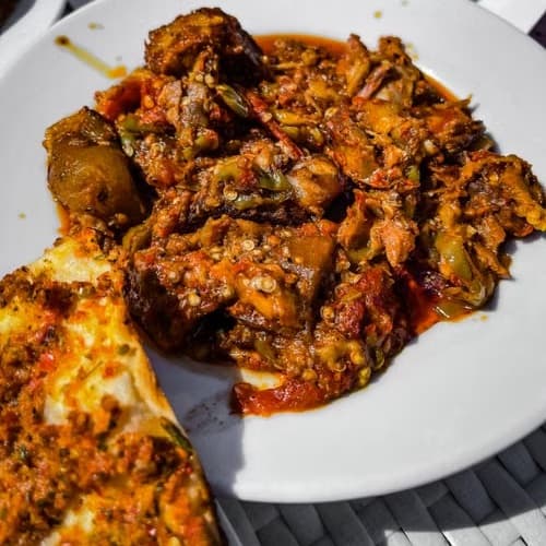 A bowl of rice and stew made with Efamy chilli sauce